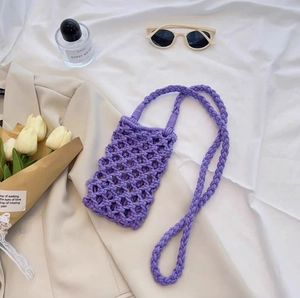 Detail shot of purple hand-woven phone bag with crochet texture and crossbody strap