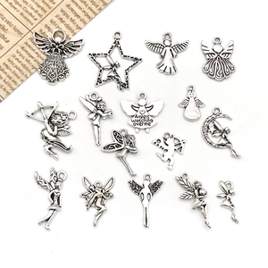 Flat lay of vintage silver angel pendants in various shapes for DIY jewelry making