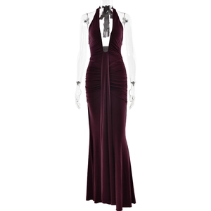 Detail view of burgundy halter neck dress featuring pleated waist and fishtail hemline