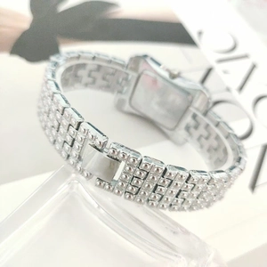 Detailed back view of a silver crystal watch with stainless steel case and folding clasp
