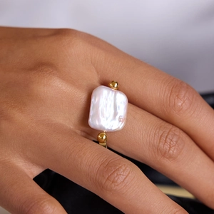 Minimalist stainless steel ring featuring a large square baroque pearl with gold accents