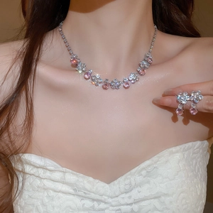 Detailed view of model wearing pink zircon floral necklace and earrings jewelry set
