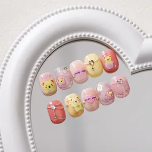 Detailed view of pink and yellow 5D relief nail stickers with 3D bears and heart patterns