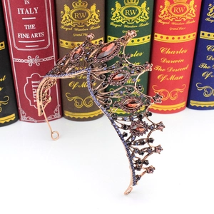 Detail of baroque crown featuring bronze butterfly frame with brown and purple crystals