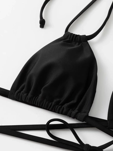 Close-up of black drawstring bikini top featuring adjustable ties and matte texture