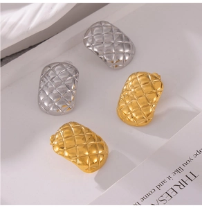 Detailed view of geometric diamond-patterned studs in gold and silver plating