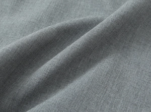 Close-up of grey satin fabric texture with soft drapes and elegant silk-like sheen