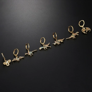 Detailed flat lay of golden dinosaur hoop earrings set with vibrant colorful zircon stones