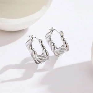 Polished silver twisted hoop earrings made of titanium steel with a minimalist design