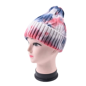 Close-up of chunky knit tie-dye beanie featuring blue, red, and white woven textures