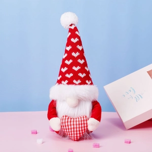 Close-up of a Christmas gnome plush with a heart pattern hat and fuzzy white beard
