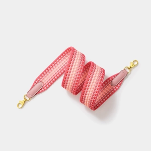 Pink and red geometric woven wide shoulder strap with pink leather and gold metal clasps