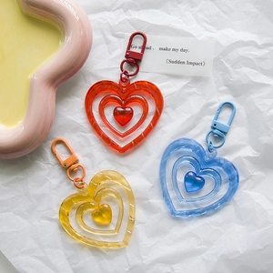 Three-layer nested heart keychain in red yellow and blue with matching metal clasp