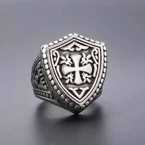 Detail shot of vintage stainless steel shield ring with gothic cross and oxidized finish
