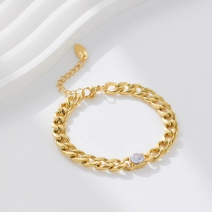 Detail of 18k gold plated stainless steel Cuban bracelet with round zircon on white background