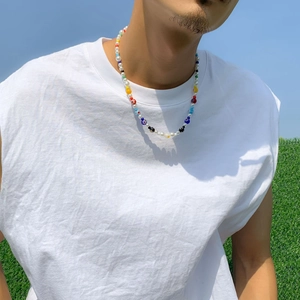 Outdoor shot of a colorful beaded necklace with glass flowers and white pearls