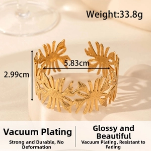 Wide hollow leaf cuff bracelet in gold finish showing 33.8g weight and 2.99cm height details
