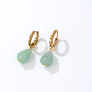 Macro detail of gold teardrop earrings with translucent light green natural stone