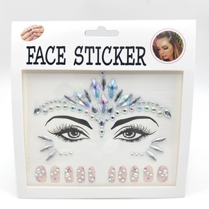 Close-up of pink floral nail stickers and acrylic face jewels in white packaging