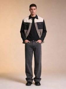Men's fashion outfit featuring a tricolor patchwork jacket and washed grey denim jeans