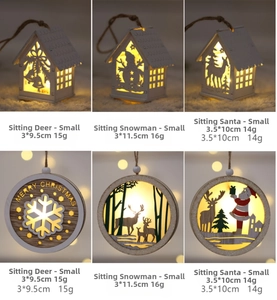 Detail view of glowing Nordic wooden Christmas house ornaments with warm LED lighting