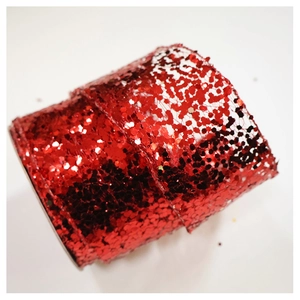 Close-up of sparkling red chiffon ribbon with glitter sequins for Christmas tree decor