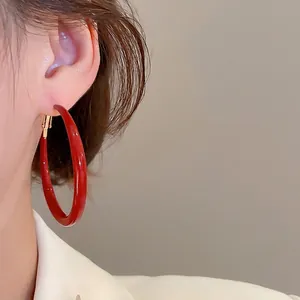 Fashionable large Ancora red enamel hoop earrings with gold pins for a minimalist style