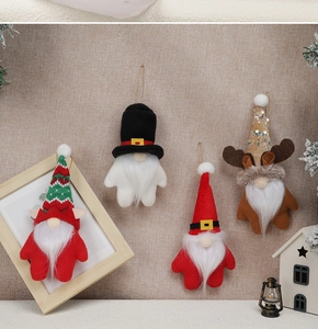Lot de quatre nains de Noël tricotés avec barbes blanches et bonnets sur fond en lin