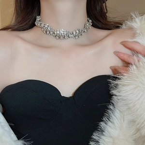 Close-up of sparkling rhinestone twisted choker necklace on model's neck for elegant look