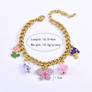Gold chain bracelet with enamel flower and blue butterfly charms, 16.5cm length detail