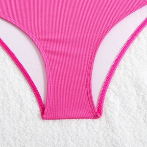 Macro shot of rose pink ribbed swimsuit fabric with high-quality stitching details