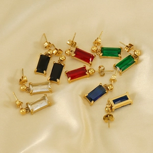 Rectangle gemstone drop earrings with gold finish arranged on silk fabric