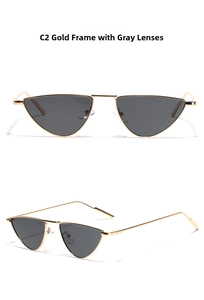 Detail of triangular cat-eye sunglasses with gold metal frame and dark grey lenses