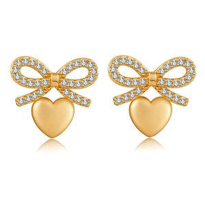 Detail of 18K gold plated bow stud earrings with sparkling stones and heart pendant