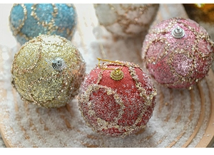 Close-up of sparkling Christmas foam balls with sequins and beads on a snowy tray