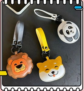 Detailed view of leather animal keychains featuring lion, shiba inu, and panda designs
