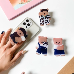 Detailed view of cute cartoon bear phone socket stands in various outfits and designs