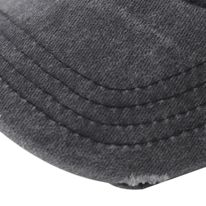 Detailed close-up of parallel stitching and distressed brim on gray cotton baseball cap