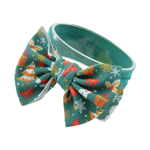 Green Christmas bow headband with holiday print on textured nylon fabric for babies