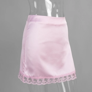 Close-up of pink satin mini skirt featuring delicate lace trim and silky texture