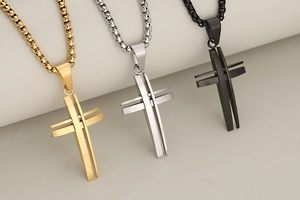 Detailed view of hollow 3D stainless steel cross pendants in gold, silver and black