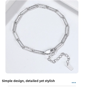 Macro shot of S925 sterling silver paperclip bracelet with lobster clasp and hallmark tag