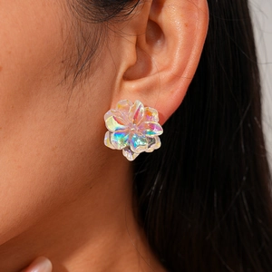 Holographic flower stud earring with rainbow resin petals on female model ear