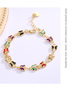 Detail of gold-plated butterfly bracelet with colorful acrylic stones and lobster clasp