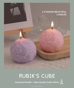 Detailed relief pattern on pink and purple sphere candles with premium cotton wick