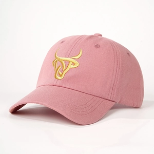 Pink vintage baseball cap with golden bull head embroidery in a stylish 45-degree angle view