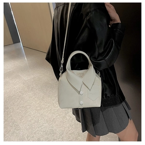 Detail shot of a white shirt collar design PU leather crossbody bag on a model
