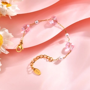 Detailed macro view of gold-plated children's chain with pink heart beads and white pearls