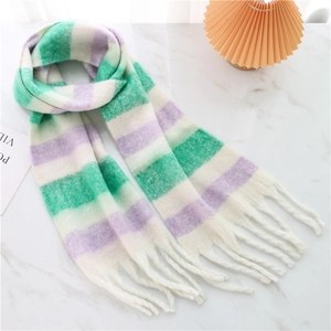 Detail of soft mohair plaid scarf with green and purple stripes and tassel fringe