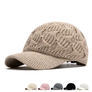 Winter knitted baseball cap for women with thick cable knit texture and curved brim